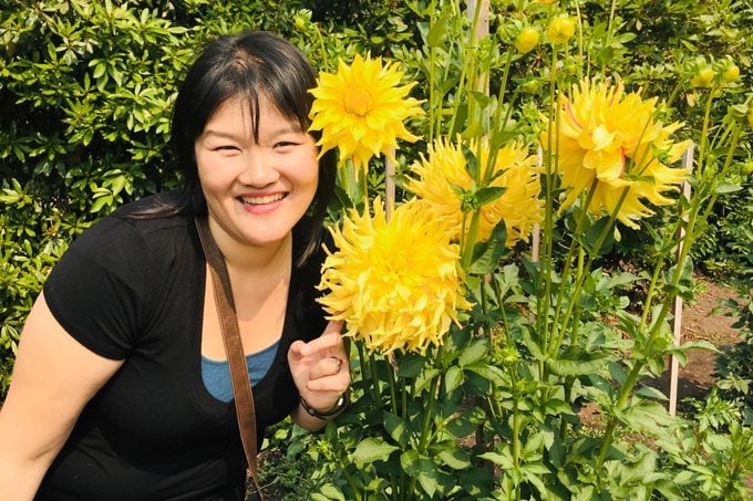 portrait of an asian American woman in a flower field