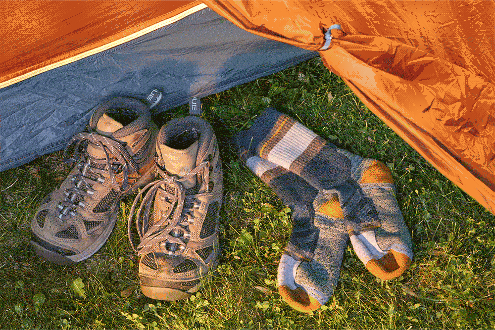 GIF of socks being rolled up and stuffed into camping boots