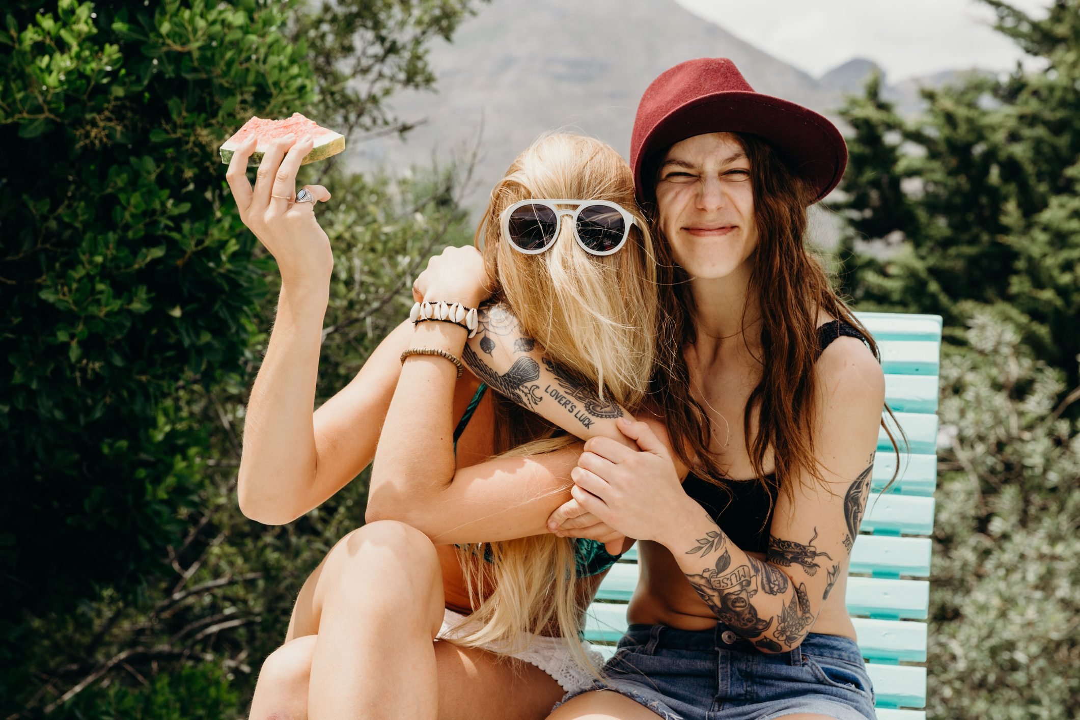 Three cute beautiful hippie girl in the setting sun, outdoors, the best of  friends smiling and