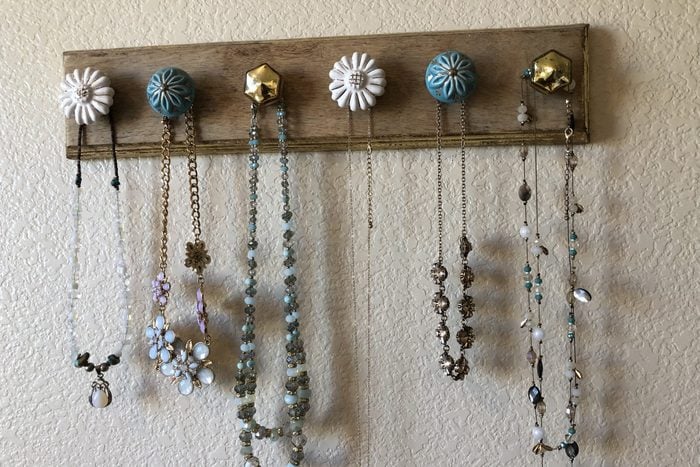 wall mounted jewelry hooks with necklaces hanging