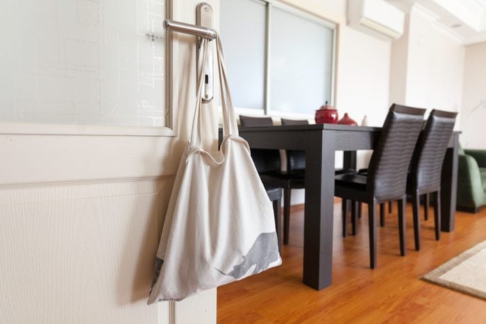 reusable tote bag hanging on a door knob