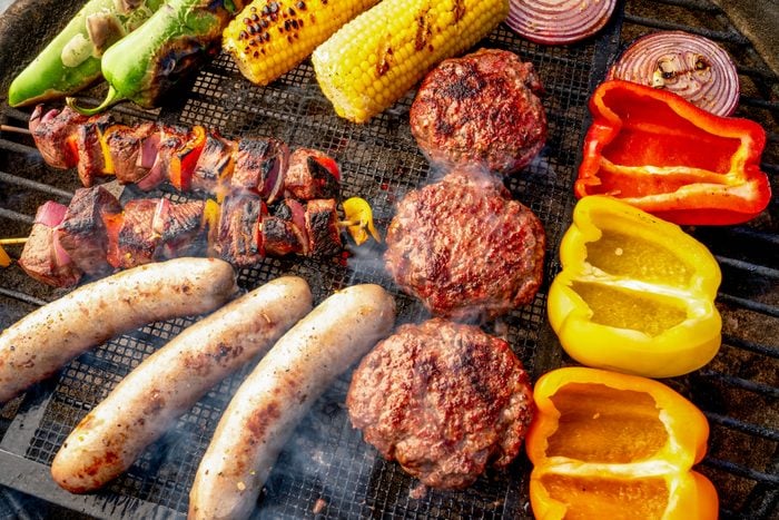 A Beautiful Mixed Grill Meat And Fresh Vegetables Arranged On A Charcoal Grill