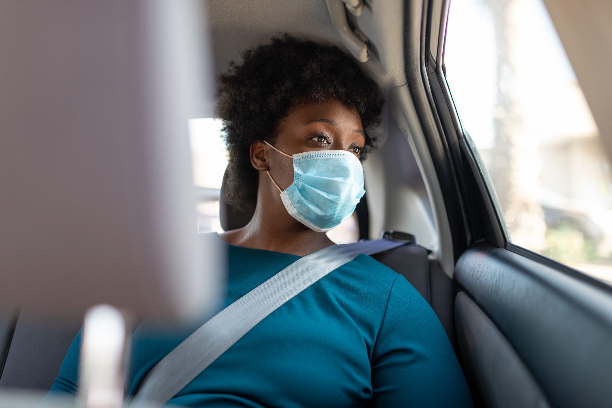 Woman traveling in a taxi during covid-19 pandemic