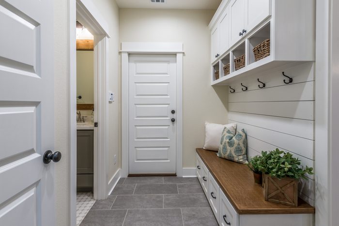 Gorgeous mudroom with white shiplap wall and cabinets