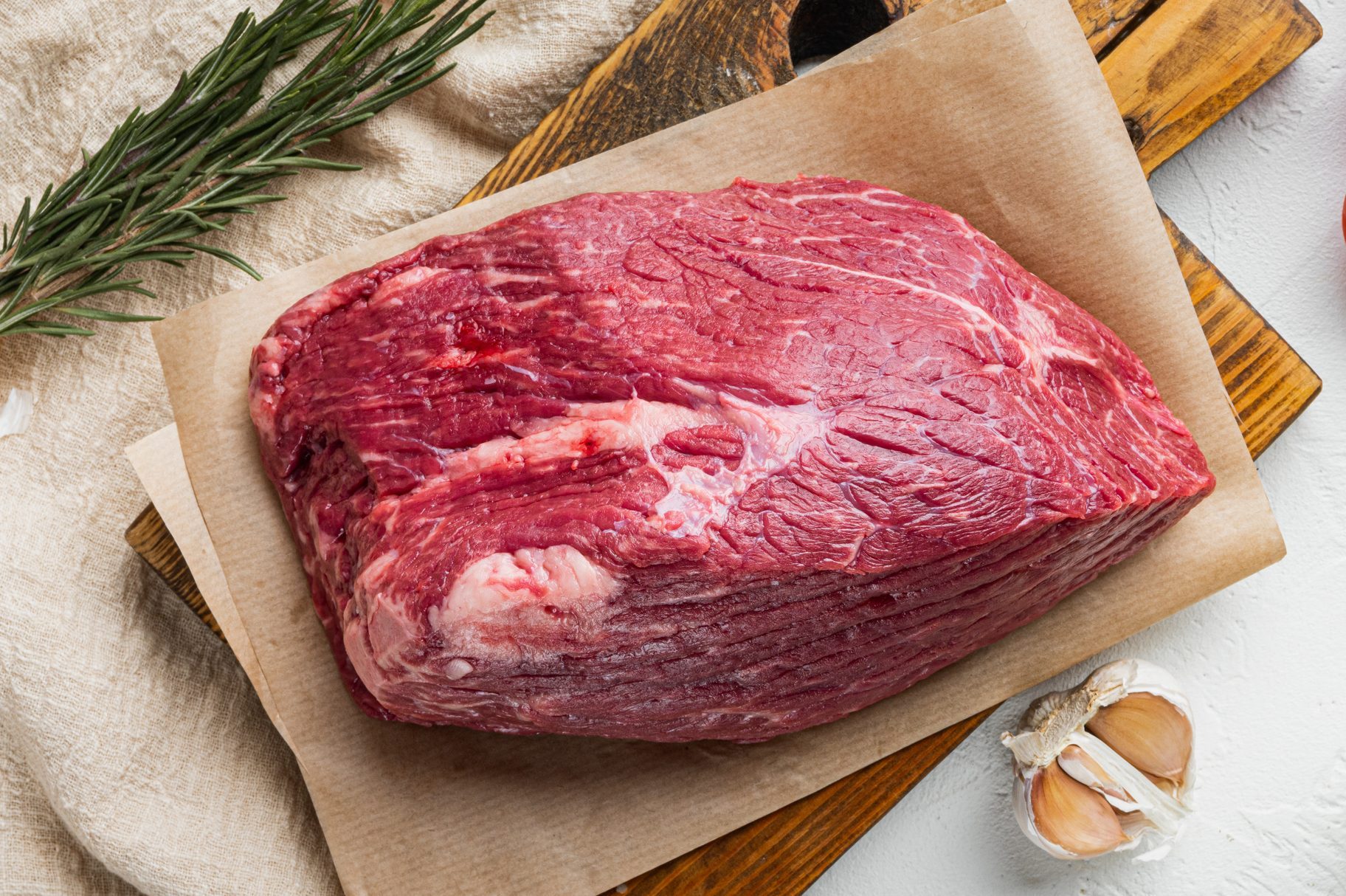 Beef cut raw, on wooden cutting board, on white background