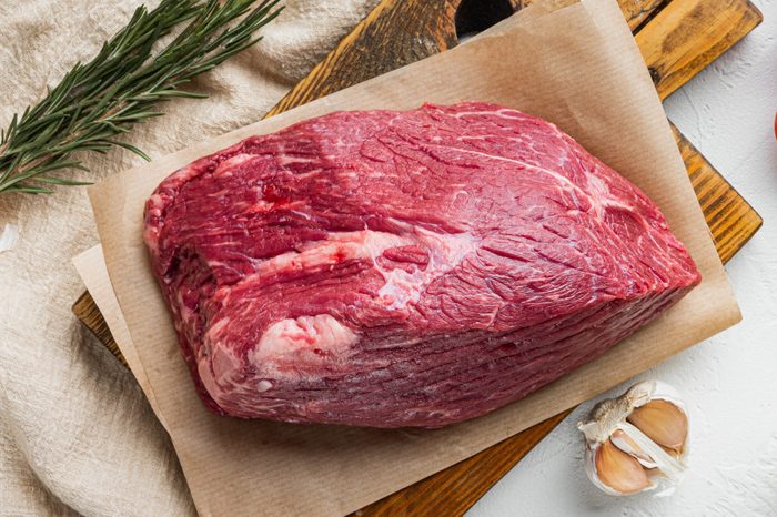 Beef cut raw, on wooden cutting board, on white background