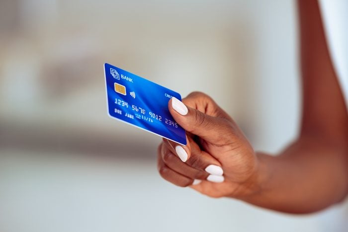 Black woman hand holding credit card