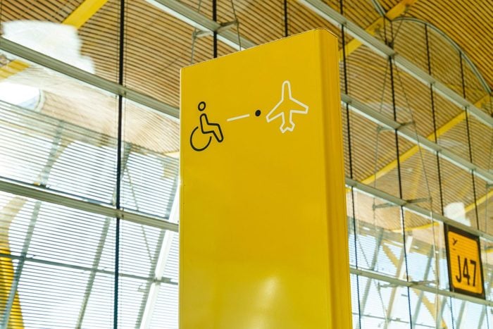 Yellow international symbol of people with disabilities at airport boarding gate