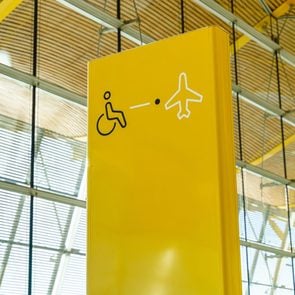 Yellow international symbol of people with disabilities at airport boarding gate