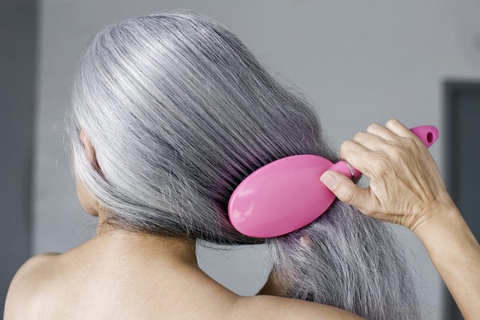 Mature woman with hair brush