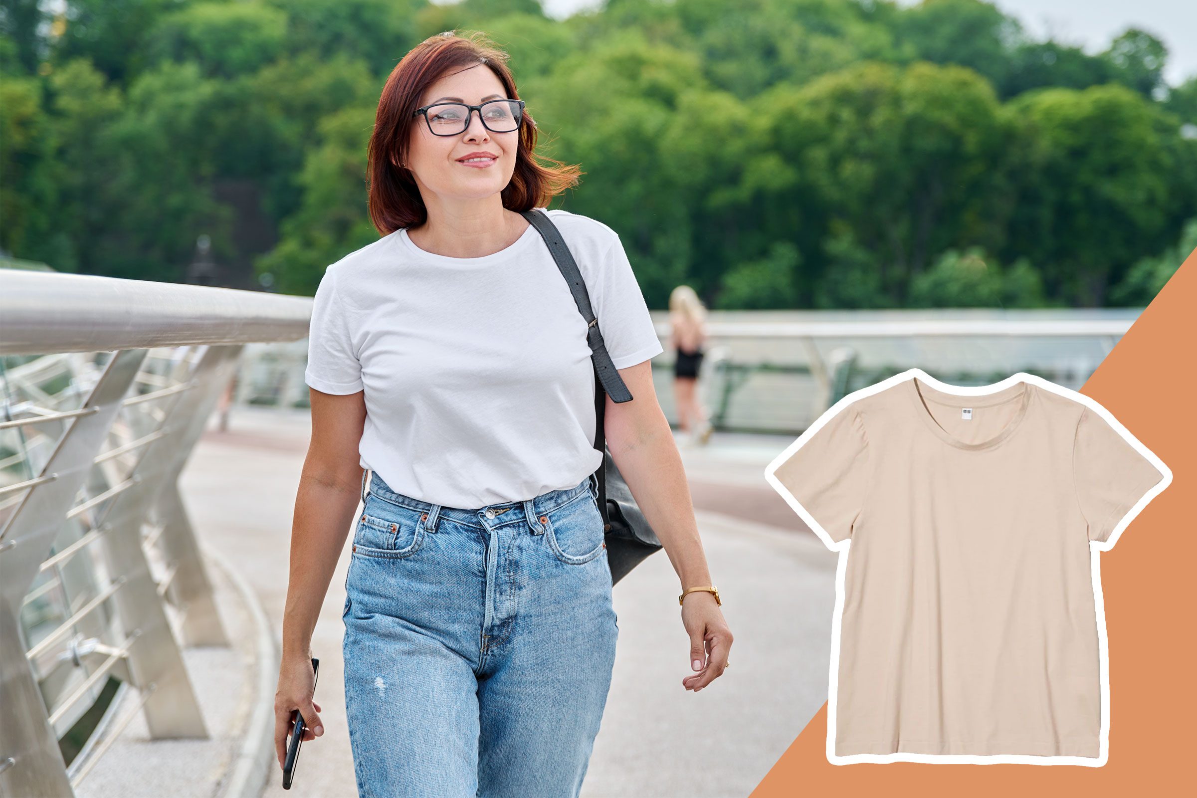 woman in a white t-shirt and jeans walking down the street