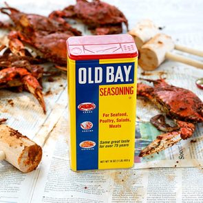 old bay seasoning on newspaper with crabs