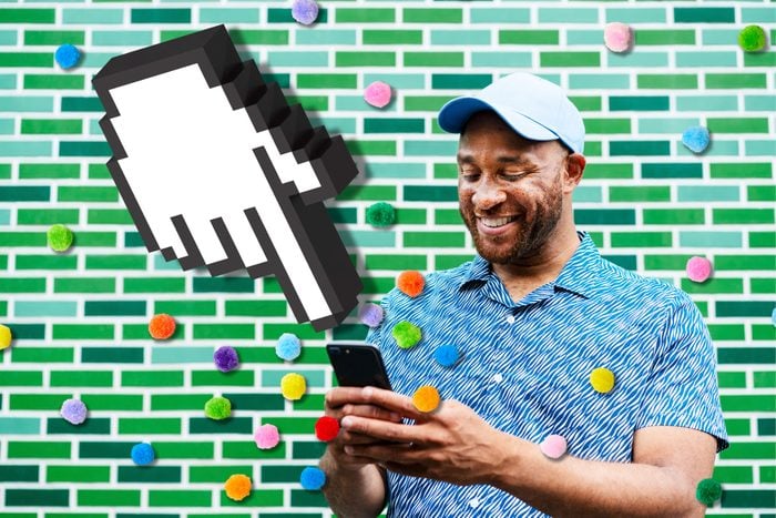 man using a smartphone agains a green tiled wall; over the photo are colored pompoms and a giant cursor hand