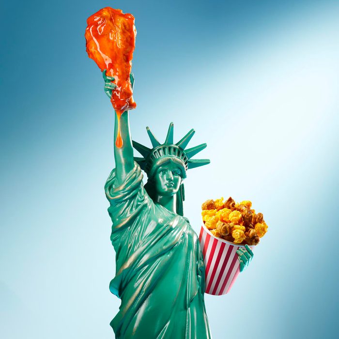 Statue of Liberty holding a buffalo wing and bucket of popcorn