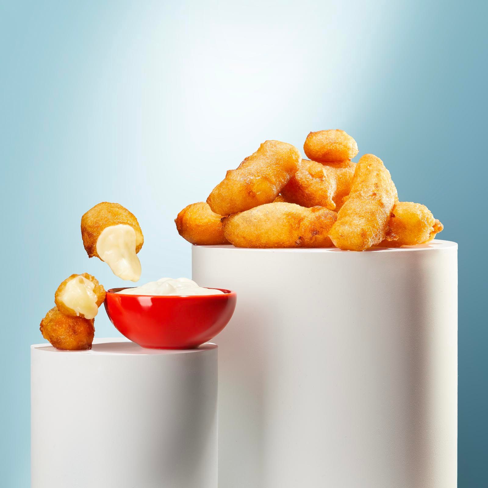 Cheese curds and dipping sauce on pedestals