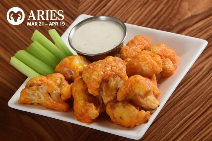 A plate of buffalo cauliflower with celery and ranch