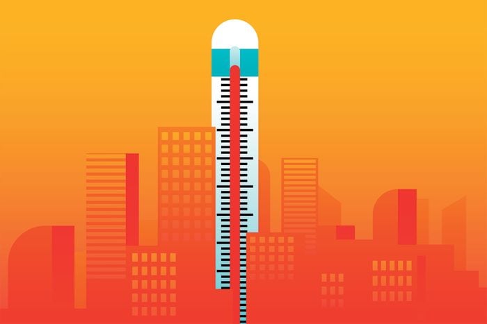 Heat Wave Concept with a Thermometer Standing Tall Above the City
