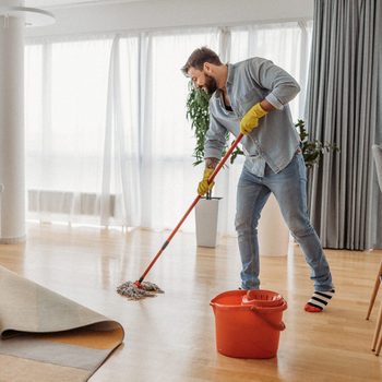 Young man cleaning his apartment