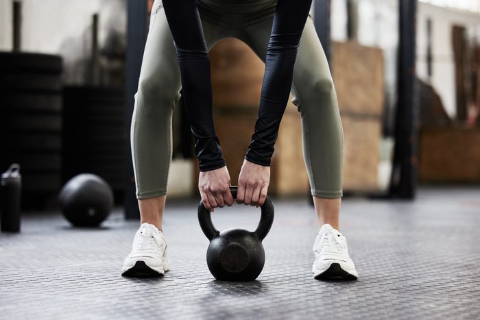 Shot of a woman working out with a kettle bell