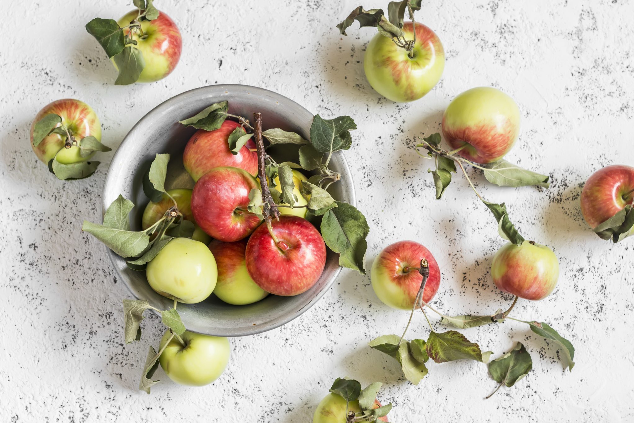 Fresh garden apples on a light background. Rustic style.