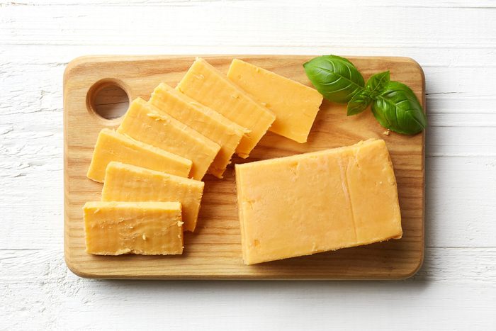 Piece and slices of cheddar cheese