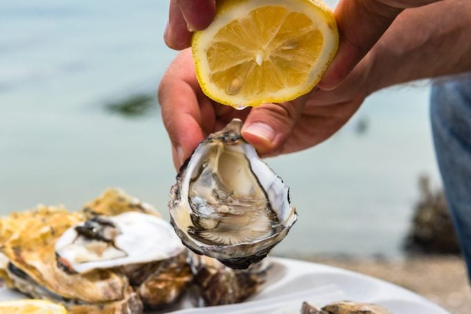 Male hand holding oysters