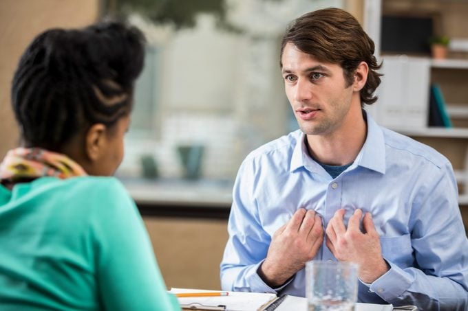 Vulnerable man discusses something with therapist