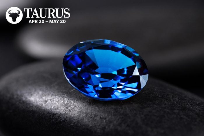 Sapphire with the Taurus symbol and dates in the upper left corner