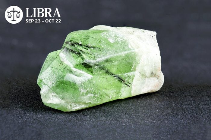 Peridot with Libra symbol and dates in the upper left corner