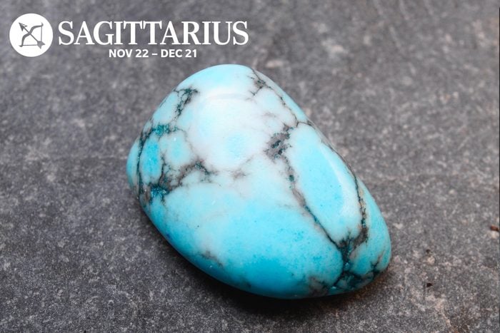 Turquoise stone with the Sagittarius symbol and dates in the upper left corner