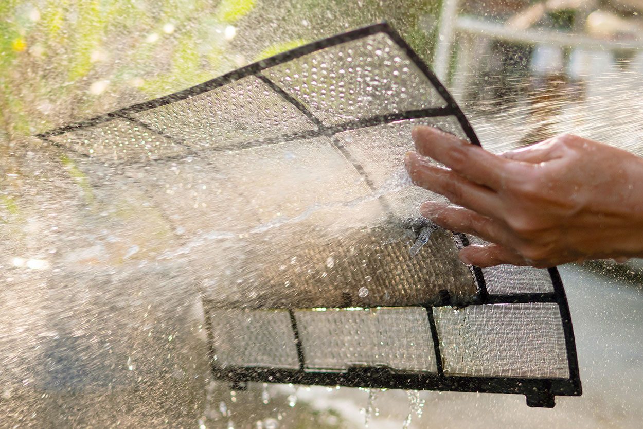 Clean The Air Conditioner Filter With Fresh Water to remove dirt dust and debris from filter screen