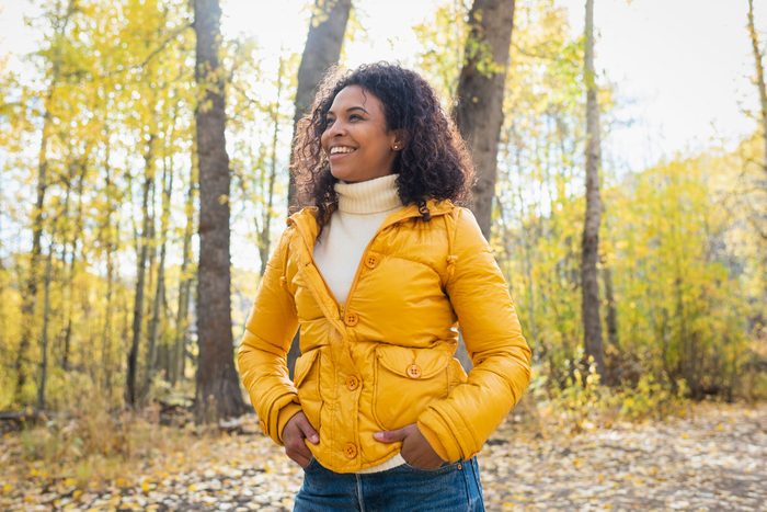 smiling woman outdoors in autumn on a sunny day