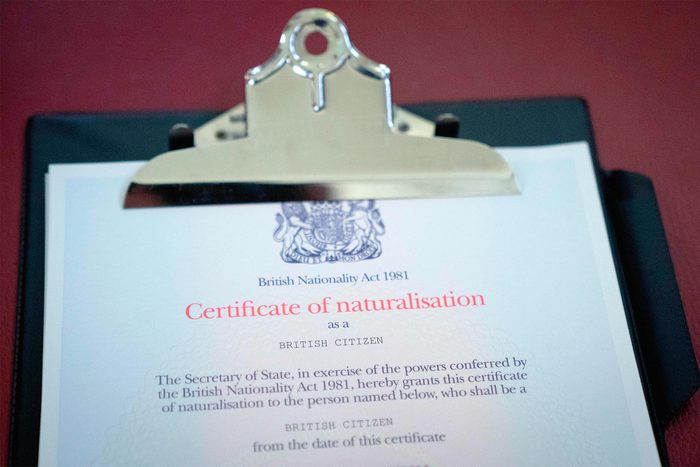 A Certificate of naturalisation is pictured on a clipboard during a citizenship ceremony at Islington Town Hall, in north London, on February 5, 2018.