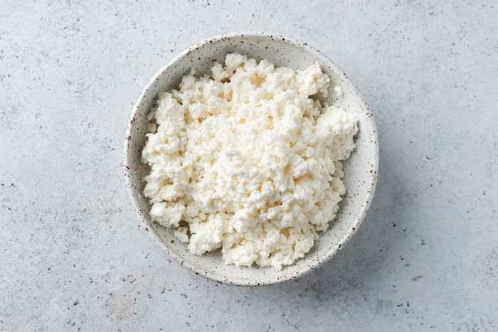 Top view of a bowl of cottage cheese on a grey counter top