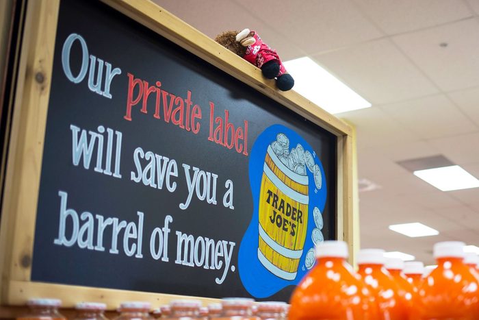 Trader Joes Sign is seen in a Trader Joes Store with a stuffed animal on top of the sign as part of the scavenger hunt for kids