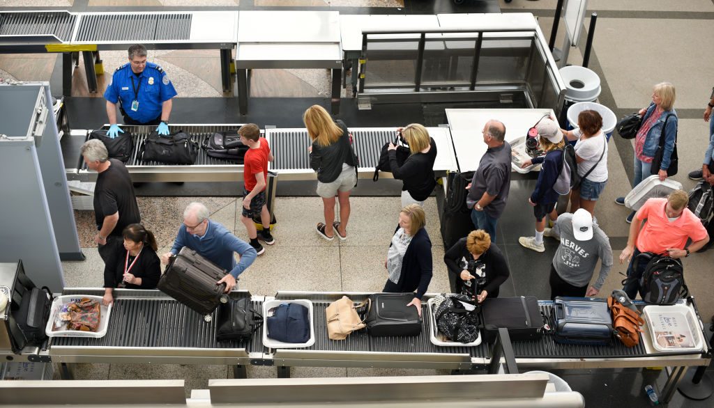  Airplane passengers line up for TSA security screenings at Denver International Airport in Denver, Colorado.