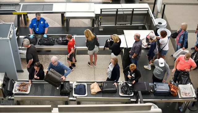 Airplane passengers line up for TSA security screenings at Denver International Airport in Denver, Colorado.