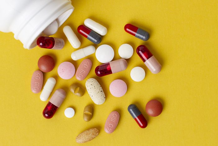 Over the counter medicines on yellow background
