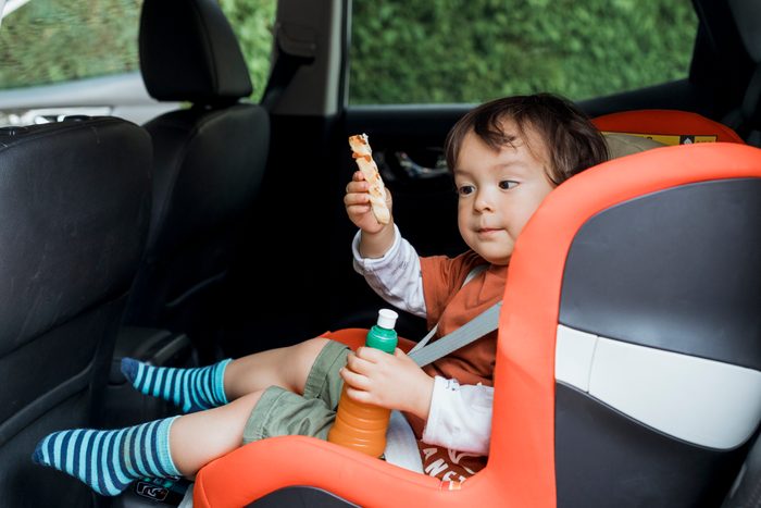 Young Boy in Carseat with Snack