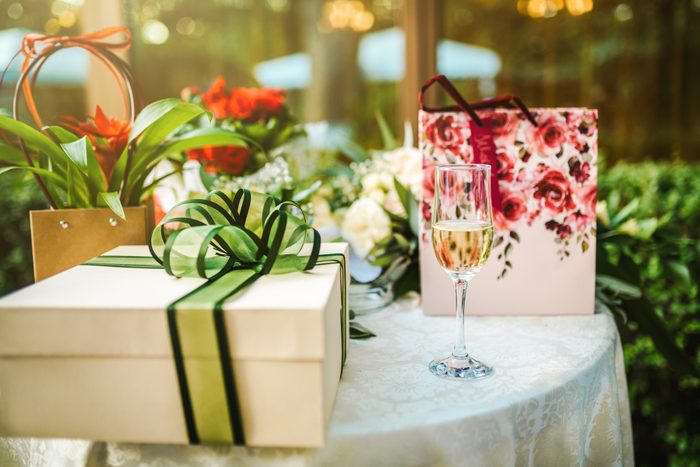 gift table at a wedding, glass of champagne next to the gifts