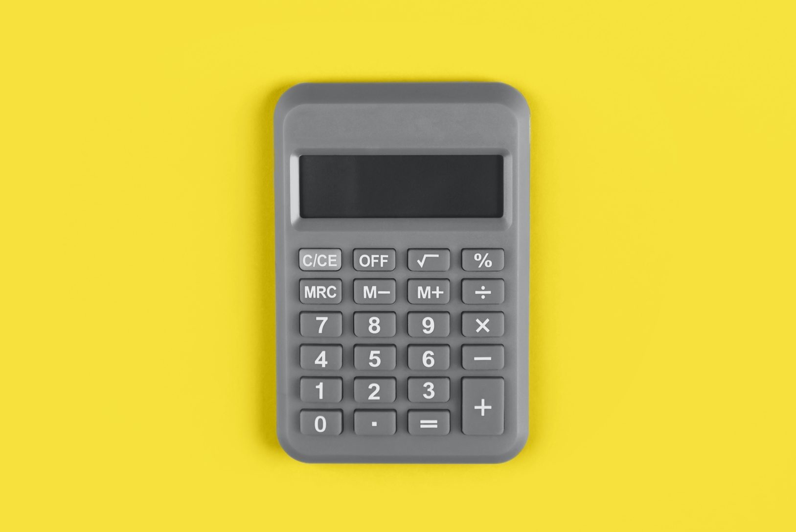 Gray calculator on a bright yellow color 2021 desk