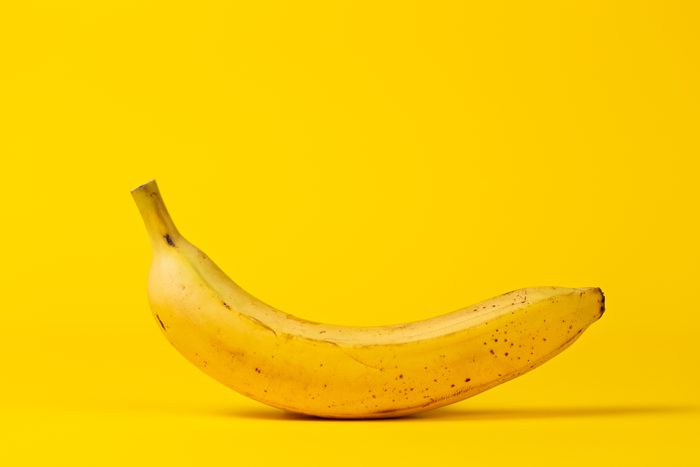 Yellow banana on a yellow background. Copy space