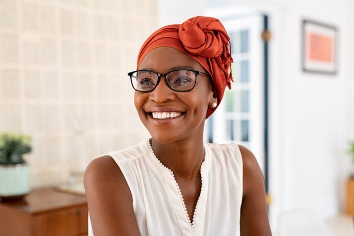 Happy smiling black woman wearing african turban