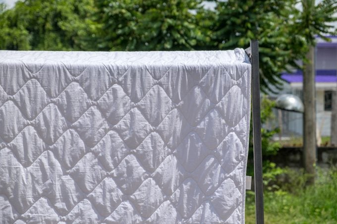 Drying Blanket on clothesline in backyard