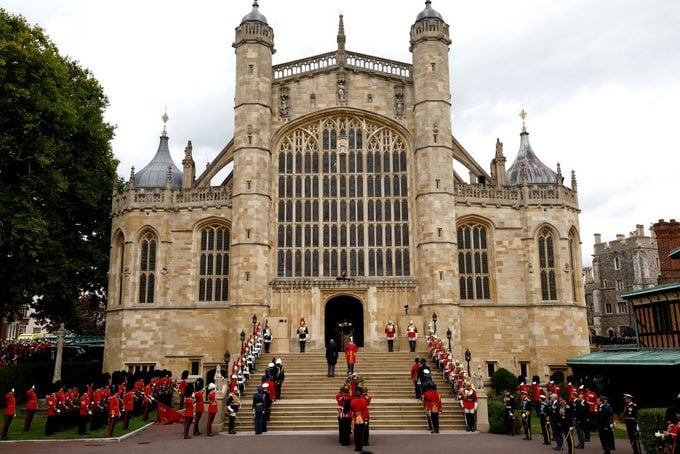 Pall bearers from the Queen's Company, 1st Battalion Grenadier Guards carry the coffin of Queen Elizabeth II with the Imperial State Crown resting on top into St. George's Chapel 