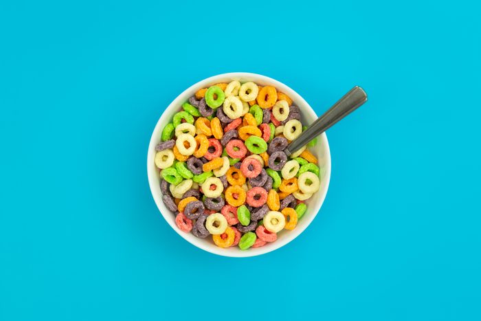 Colored breakfast cereals in a bowl on a blue background