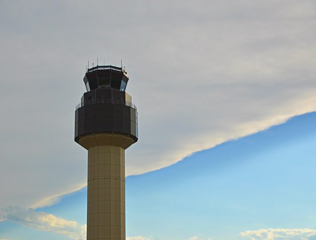 The airport control tower at Cherry Capital Airport in Traverse City, Michigan with a weather front moving in behind it.