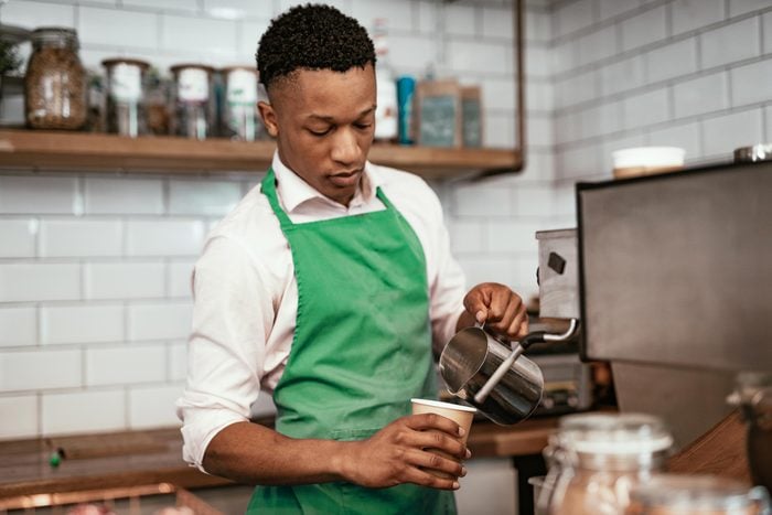 African bartender at work, making coffee
