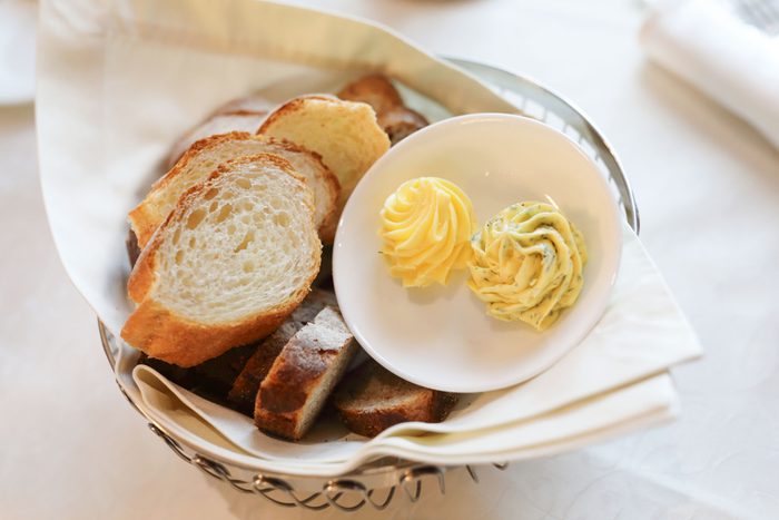bread basket with two types of butter on a restaurant table