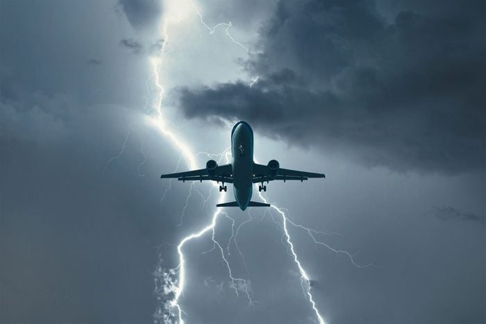Airplane flying through lightning storm